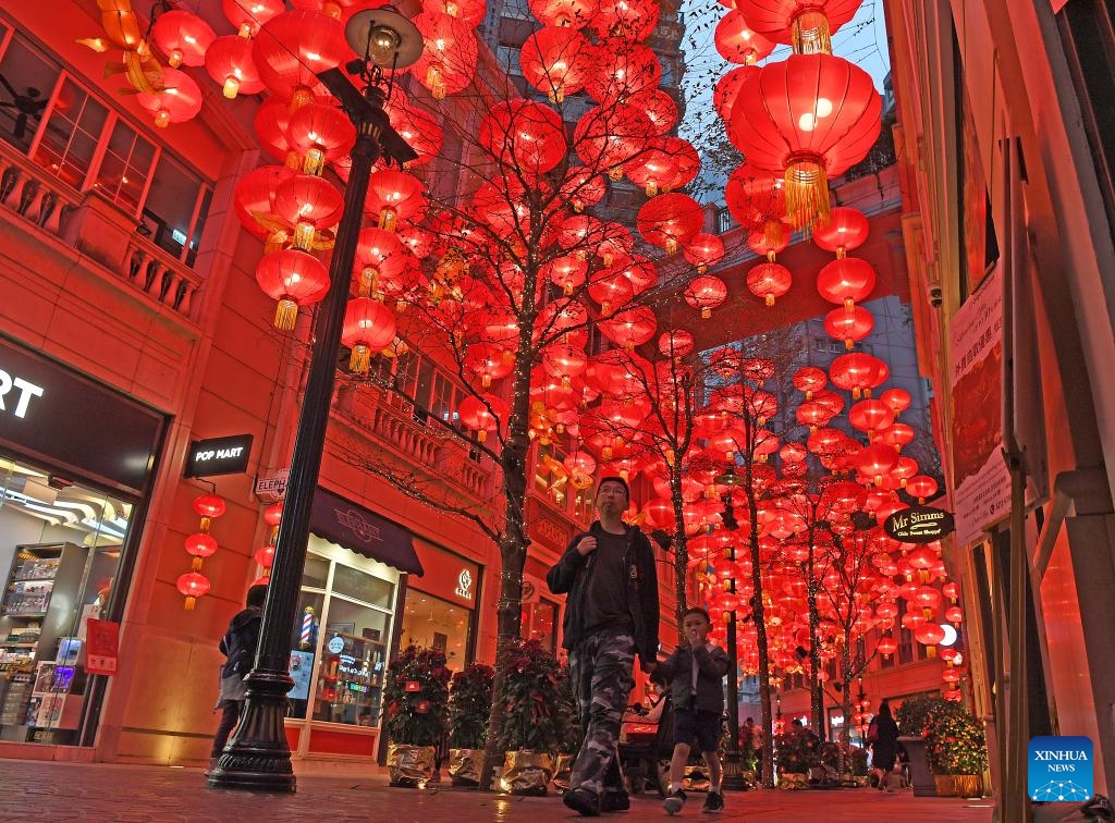 People walk past Spring Festival decorations on a street in Hong Kong, south China, Jan. 31, 2024.(Photo: Xinhua)