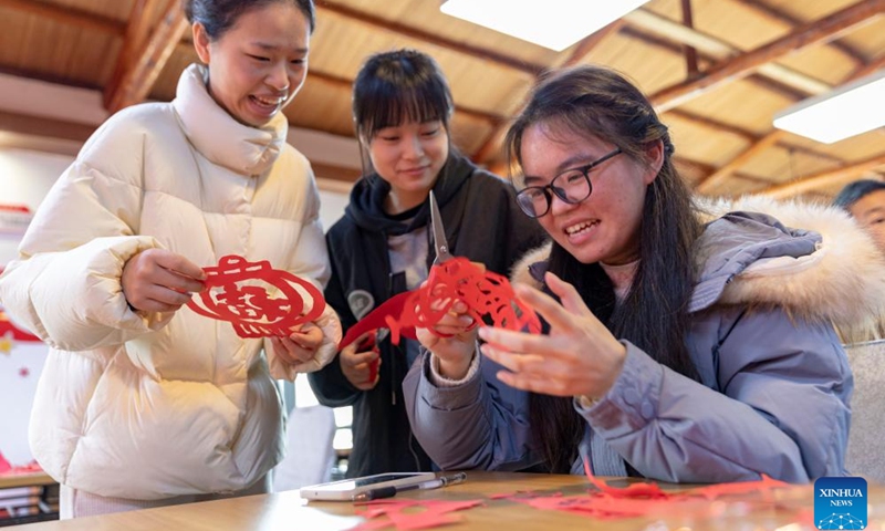 People make paper-cutting decorations together in Lushan, east China's Jiangxi Province, Jan. 31, 2024. People across China are preparing for the upcoming Spring Festival, the biggest occasion for family reunions, and heralds the beginning of spring.(Photo: Xinhua)
