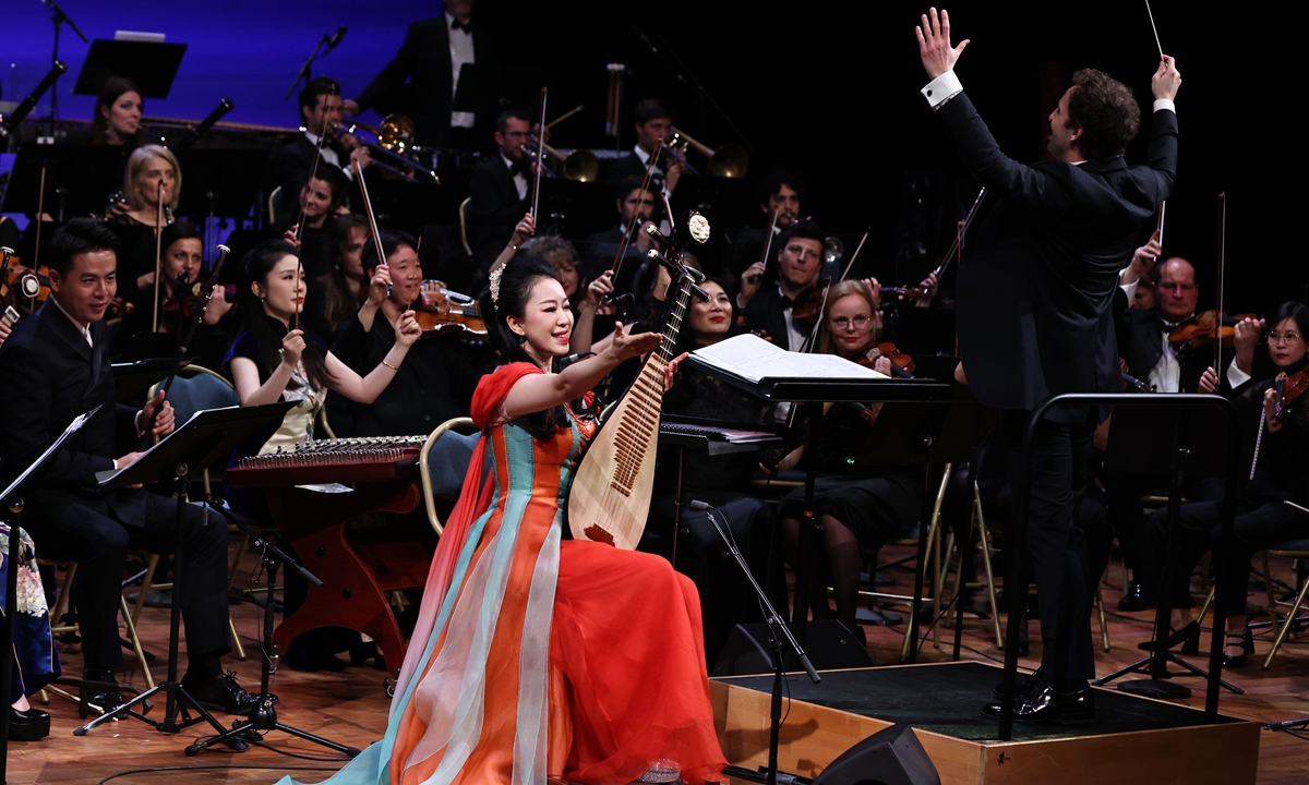 Chinese <em>pipa</em> artist Zhao Cong (front) performs with the Royal Opera of Versailles Orchestra during a concert in Paris on January 31, 2024 to celebrate the China-France Year of Culture and Tourism and the 60th anniversary of the establishment of diplomatic relations between China and France. Photo: Courtesy of the China National Traditional Orchestra