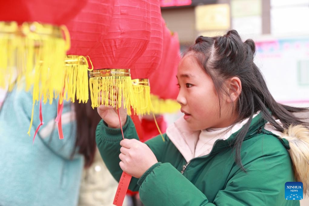 A child solves lantern riddles to welcome the Spring Festival in Qiandongnan Miao and Dong Autonomous Prefecture, southwest China's Guizhou Province, Jan. 31, 2024. People across China are preparing for the upcoming Spring Festival, the biggest occasion for family reunions, and heralds the beginning of spring.(Photo: Xinhua)