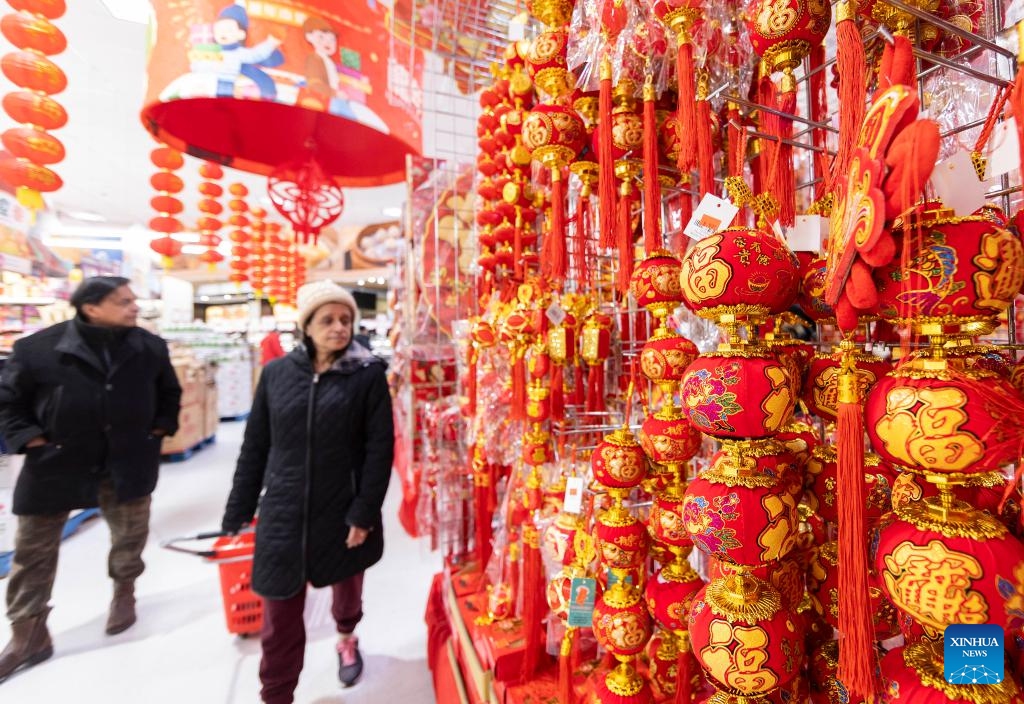 People shop at a supermarket with decorations marking the upcoming Chinese Lunar New Year in Toronto, Canada, on Feb. 2, 2024. Many shopping malls and supermarkets here have put up themed decorations to celebrate the upcoming Chinese Lunar New Year of the Dragon.(Photo: Xinhua)