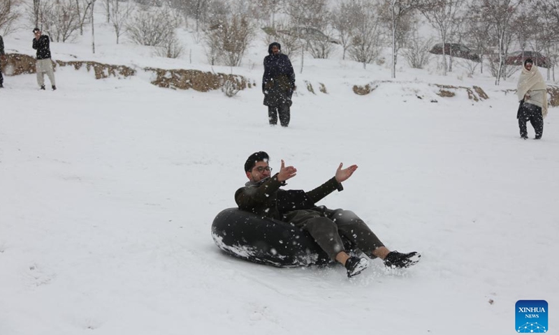 People play in snow in Kabul, capital of Afghanistan, Feb. 3, 2024. (Photo by Saifurahman Safi/Xinhua)