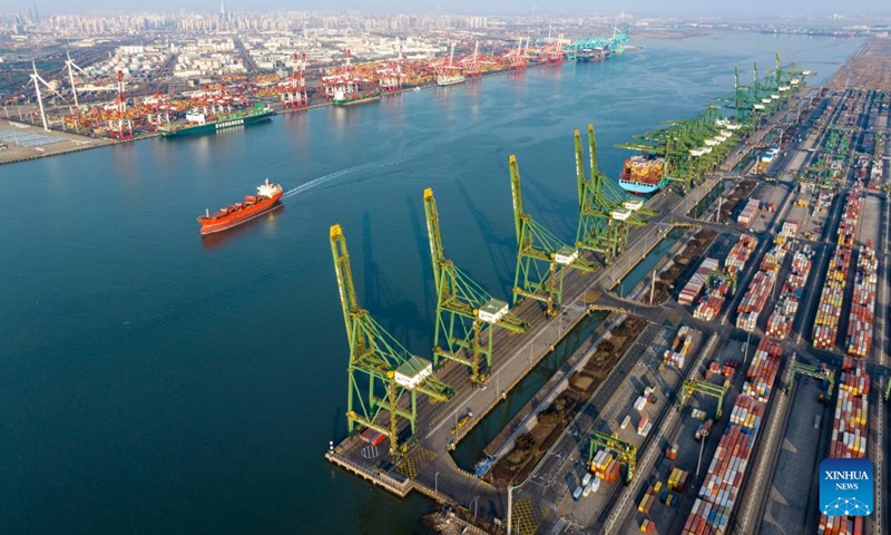 An aerial drone photo taken on Feb. 2, 2024 shows a cargo ship sailing in the main channel of Tianjin Port in north China's Tianjin. Tianjin Port, located on the coast of the Bohai Sea, is a major shipping point in north China.