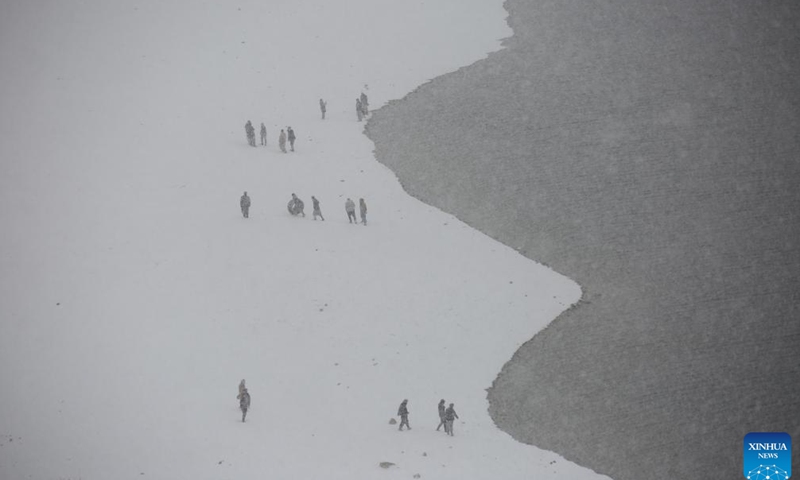 This photo taken on Feb. 3, 2024 shows the snow view by a lake in Kabul, capital of Afghanistan. (Photo by Saifurahman Safi/Xinhua)