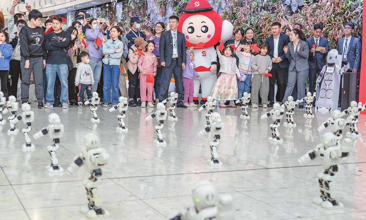 A group of robots perform a dance to cheer up passengers at a high-speed rail station in Hong Kong on February 4, 2024. With the Chinese Lunar New Year approaching, many Hong Kong residents choose to travel to the mainland by rail. Photo: VCG