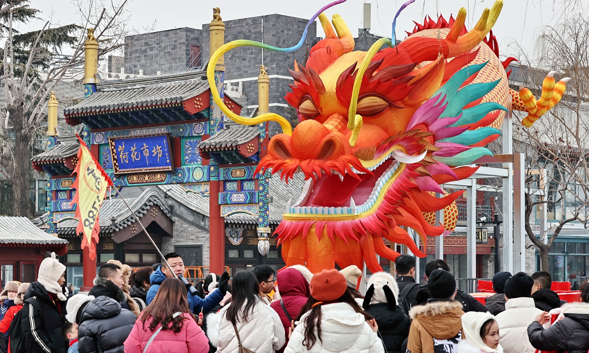 A giant dragon decoration makes its debut at the Shichahai Lotus Market in Beijing on February 4, 2024, attracting local residents and tourists to take photos to mark the upcoming Year of the Dragon which begins on February 10, 2024. Photo: VCG