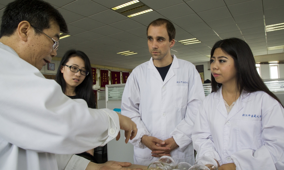 Tim Vukan (second right) learns about acupuncture and cupping from an instructor at the Zhejiang Chinese Medical University. Photo: Courtesy of Tim Vukan 