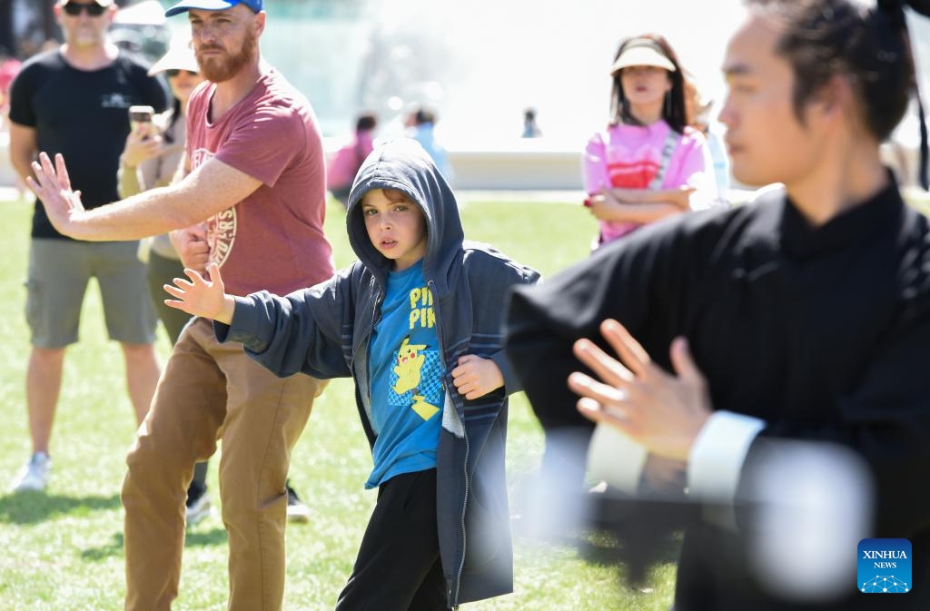 People learn Chinese Wudang Kongfu during the Happy Chinese New Year Beach Carnival in Auckland, New Zealand, Feb. 4, 2024. The Happy Chinese New Year Beach Carnival, co-hosted by the China Cultural Centre in Auckland and the Asian Community Engagement Trust, was held at the Mission Bay Beach in Auckland on Sunday. (Xinhua/Guo Lei)