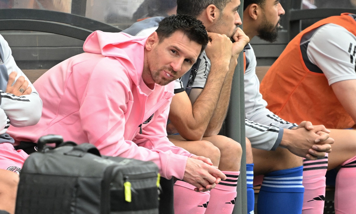 Inter Miami's Argentine forward Lionel Messi (left) sits on the bench during the friendly soccer match between a Hong Kong soccer team and Inter Miami CF in Hong Kong on February 4, 2024. Inter Miami were booed off the pitch with fans shouting refund after Messi failed to take the field as the organizer had promised. Photo: VCG