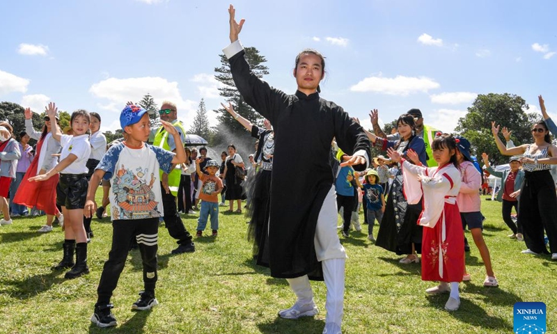 People learn Chinese Wudang Kongfu during the Happy Chinese New Year Beach Carnival in Auckland, New Zealand, Feb. 4, 2024. The Happy Chinese New Year Beach Carnival, co-hosted by the China Cultural Centre in Auckland and the Asian Community Engagement Trust, was held at the Mission Bay Beach in Auckland on Sunday. (Xinhua/Guo Lei)