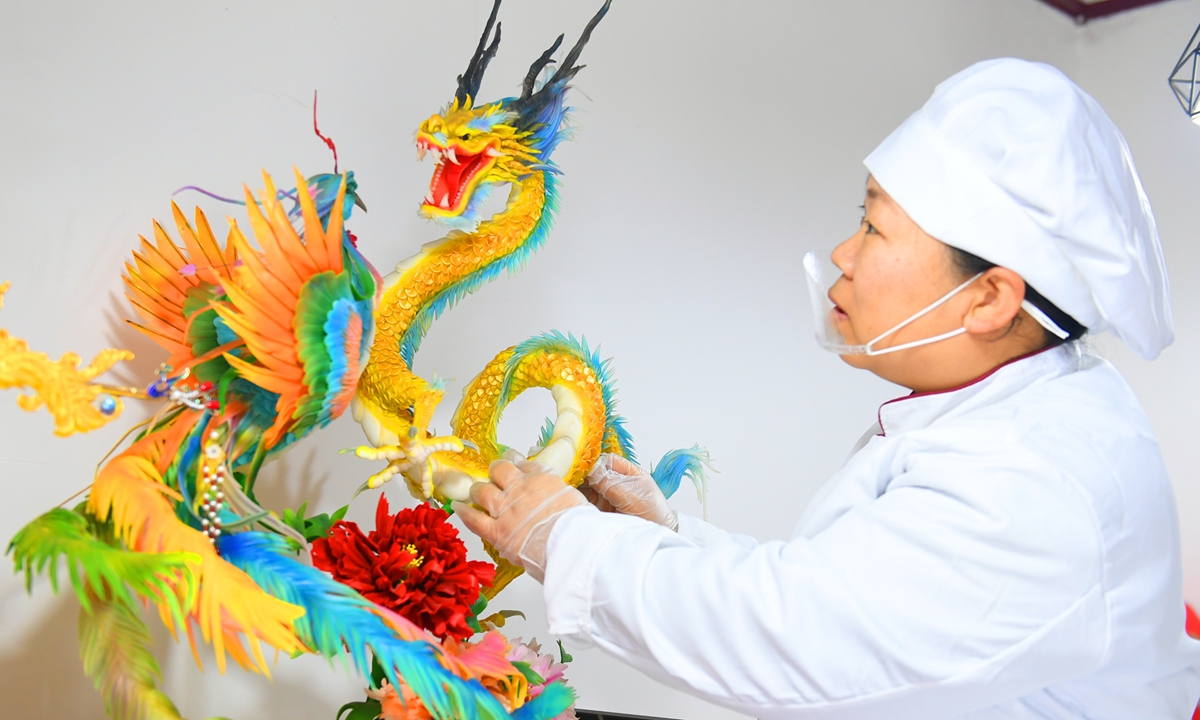 Artist Zhang Yonghong makes a dragon-shaped nianmo, a local type of steamed bun that carries blessings for the Spring Festival, on February 2, 2024, in the Jishan County in Shanxi. During an inspection trip to Shanxi in January 2022, Xi joined a local family in making nianmo. Photo: VCG