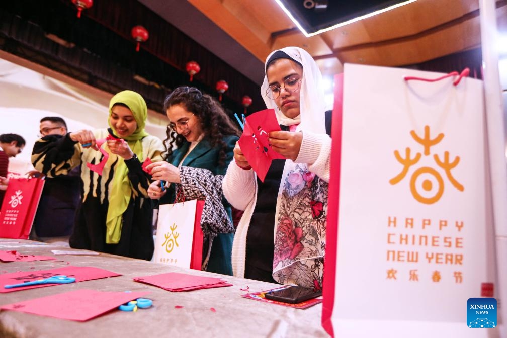 Visitors try paper-cutting during a celebration to mark the upcoming Chinese Lunar New Year in Cairo, Egypt, Feb. 3, 2024. The event, sponsored by the China Cultural Center in Cairo, was attended by about 80 participants from seven Egyptian provinces.(Photo: Xinhua)