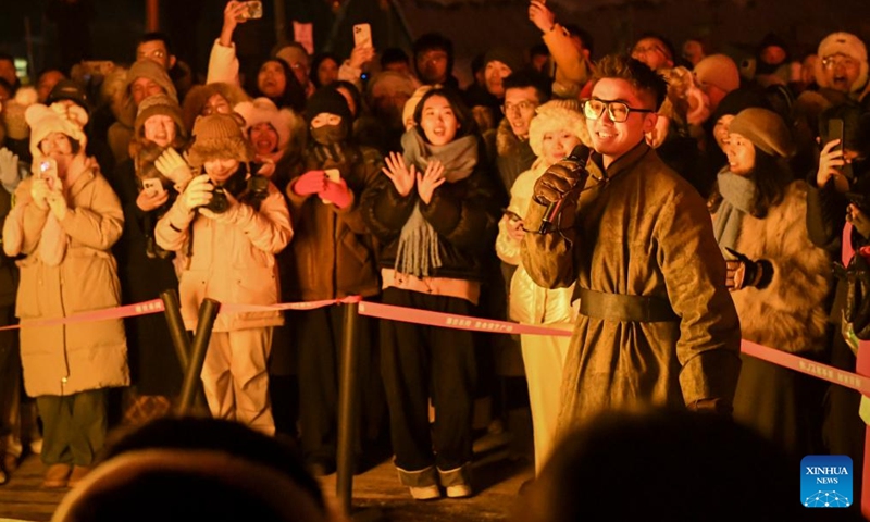 A singer stages a show for tourists during a bonfire activity in Hemu Village in Altay Prefecture, northwest China's Xinjiang Uygur Autonomous Region, Feb. 1, 2024. Tucked away within Altay Prefecture, Hemu Village in Xinjiang offers the perfect winter getaway. As the Spring Festival is approaching, the village has become a hot spot for tourists.(Photo: Xinhua)