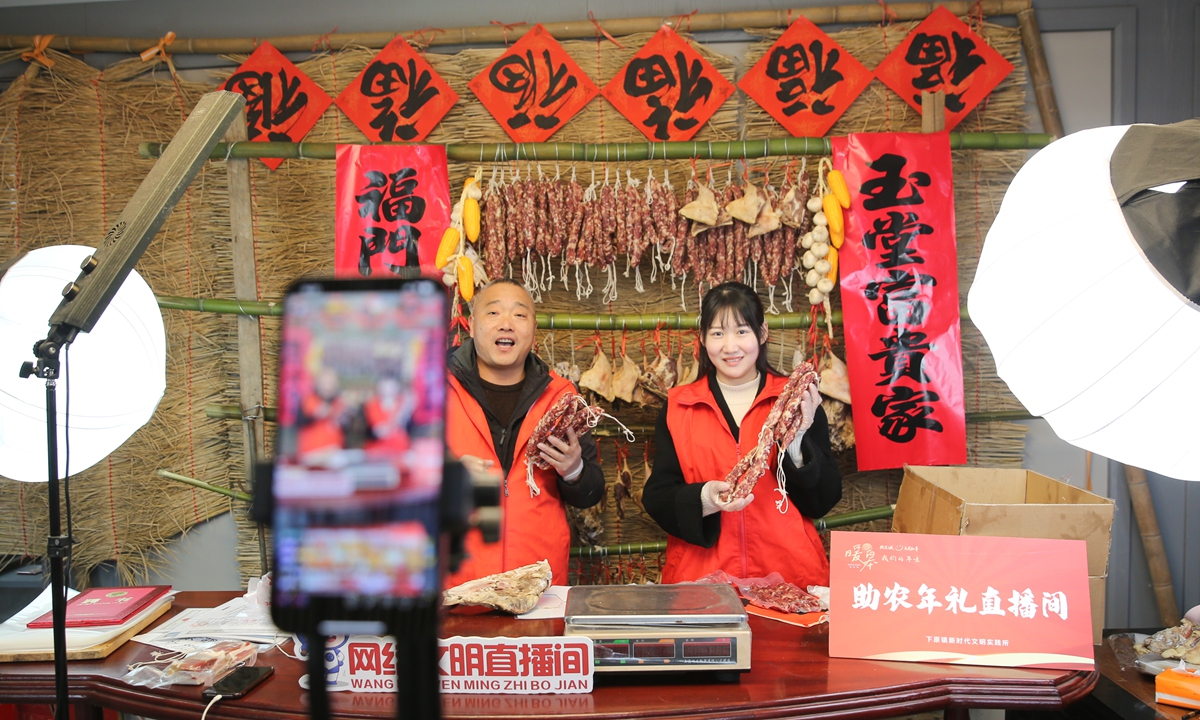 Villagers promote sausages and dried meats via an online platform at a community in Nantong, East China’s Jiangsu Province, on January 9, 2024. 