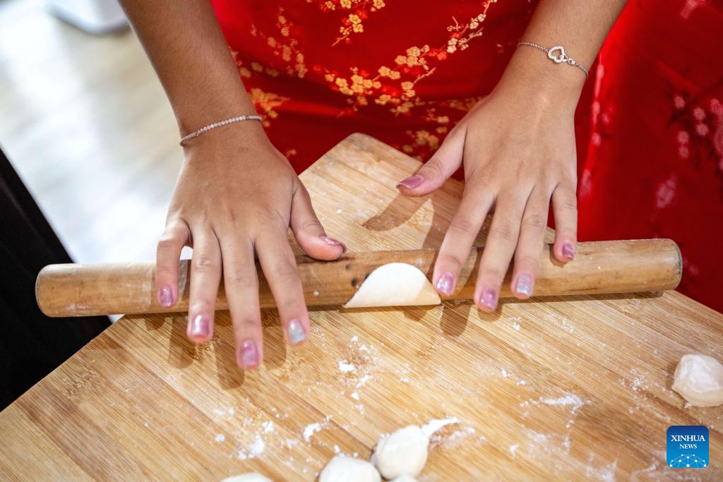 A Thai student makes dumplings during an event celebrating the upcoming Chinese Lunar New Year, or the Spring Festival, at Thammasat University in Bangkok, Thailand, Feb. 5, 2024.(Photo: Xinhua)