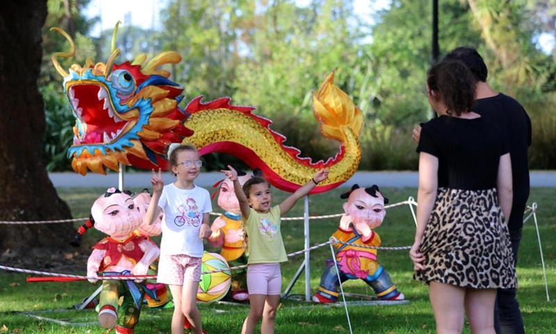 Children pose for photos in front of a dragon-shaped installation to welcome the Chinese Lunar New Year at Hagley Park in Christchurch, New Zealand, Feb. 9, 2024. Photo: Xinhua