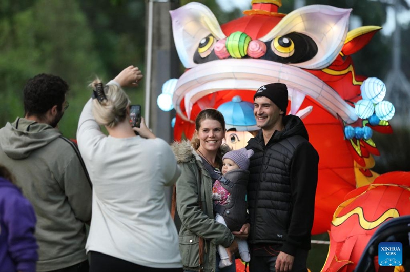 Tourists pose for photos in front of a dragon-shaped installation to welcome the Chinese Lunar New Year at Hagley Park in Christchurch, New Zealand, Feb. 9, 2024. Photo: Xinhua