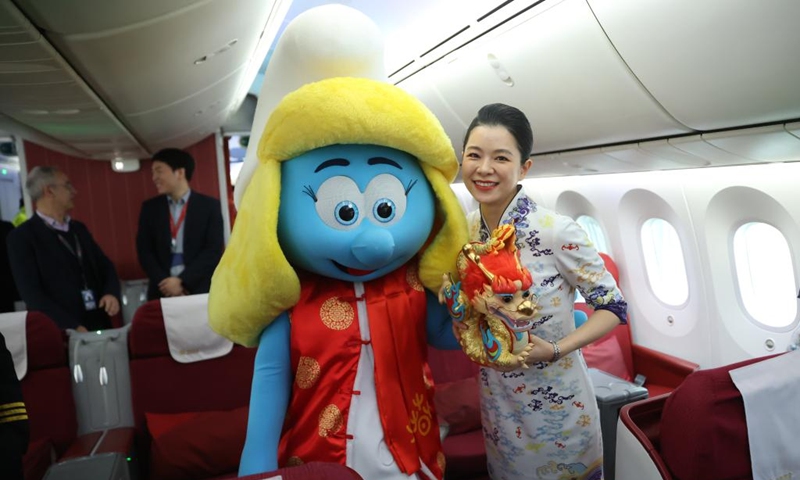 A staff member poses with a smurf costumed character wearing traditional Chinese clothes at the Brussels Airport in Zaventem, Belgium, Feb. 9, 2024. The festive atmosphere to welcome the Chinese Lunar New Year fills the air at the Brussels Airport with various celebration activities held here. Photo: Xinhua