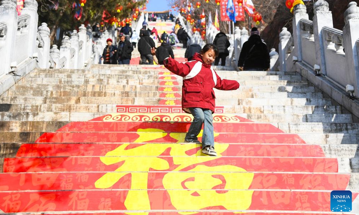 Tourists visit a temple fair in Pinggu District of Beijing, capital of China, Feb. 13, 2024. People across China are enjoying temple fairs, lantern shows and other events to celebrate the Chinese Lunar New Year and embrace the festive atmosphere. (Xinhua/Ren Chao)





