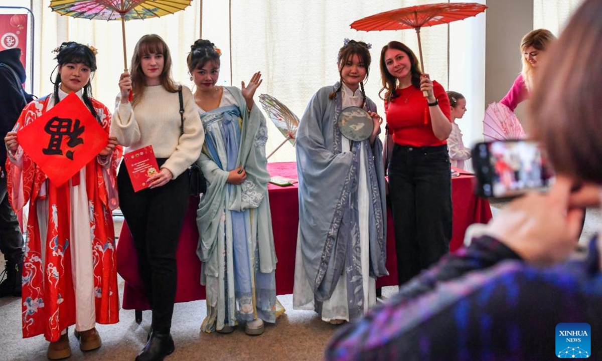 Visitors pose for photos with Chinese youngsters in traditional costume during an event celebrating the Chinese Lunar New Year, or the Spring Festival, in Moscow, Russia, Feb. 11, 2024. (Xinhua/Cao Yang)


