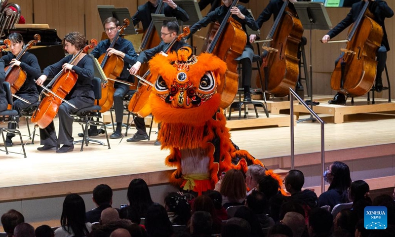Lion dancers perform while the Toronto Symphony Orchestra plays Welcoming Spring at Roy Thomson Hall in Toronto, Canada, Feb. 13, 2024. A concert in celebration of the Chinese New Year of the Dragon was held here by the Toronto Symphony Orchestra on Tuesday. (Photo: Xinhua)