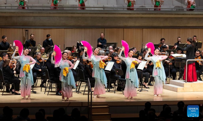 Dressed-up dancers perform while the Toronto Symphony Orchestra plays Flower Drum Song from Feng Yang from Folk Songs for Orchestra at Roy Thomson Hall in Toronto, Canada, Feb. 13, 2024. A concert in celebration of the Chinese New Year of the Dragon was held here by the Toronto Symphony Orchestra on Tuesday. (Photo: Xinhua)