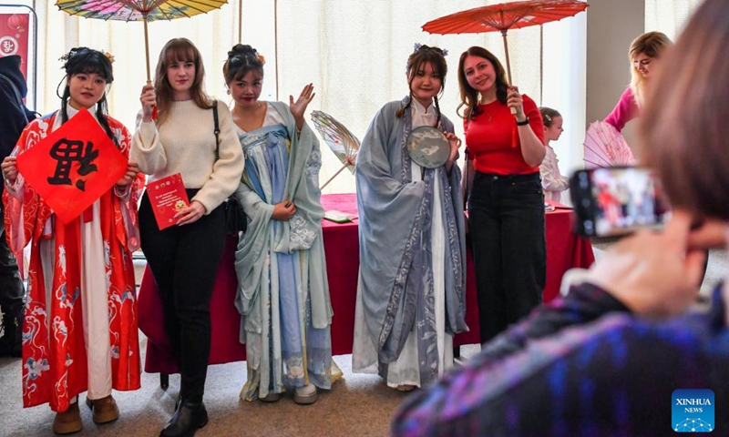 Visitors pose for photos with Chinese youngsters in traditional costume during an event celebrating the Chinese Lunar New Year, or the Spring Festival, in Moscow, Russia, Feb. 11, 2024. (Photo: Xinhua)