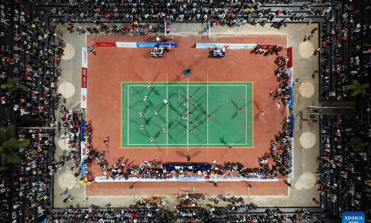 An aerial drone photo taken on Feb. 2, 2024 shows people watching a village volleyball match in Wenchang, south China's Hainan Province. (Xinhua/Zhang Liyun)