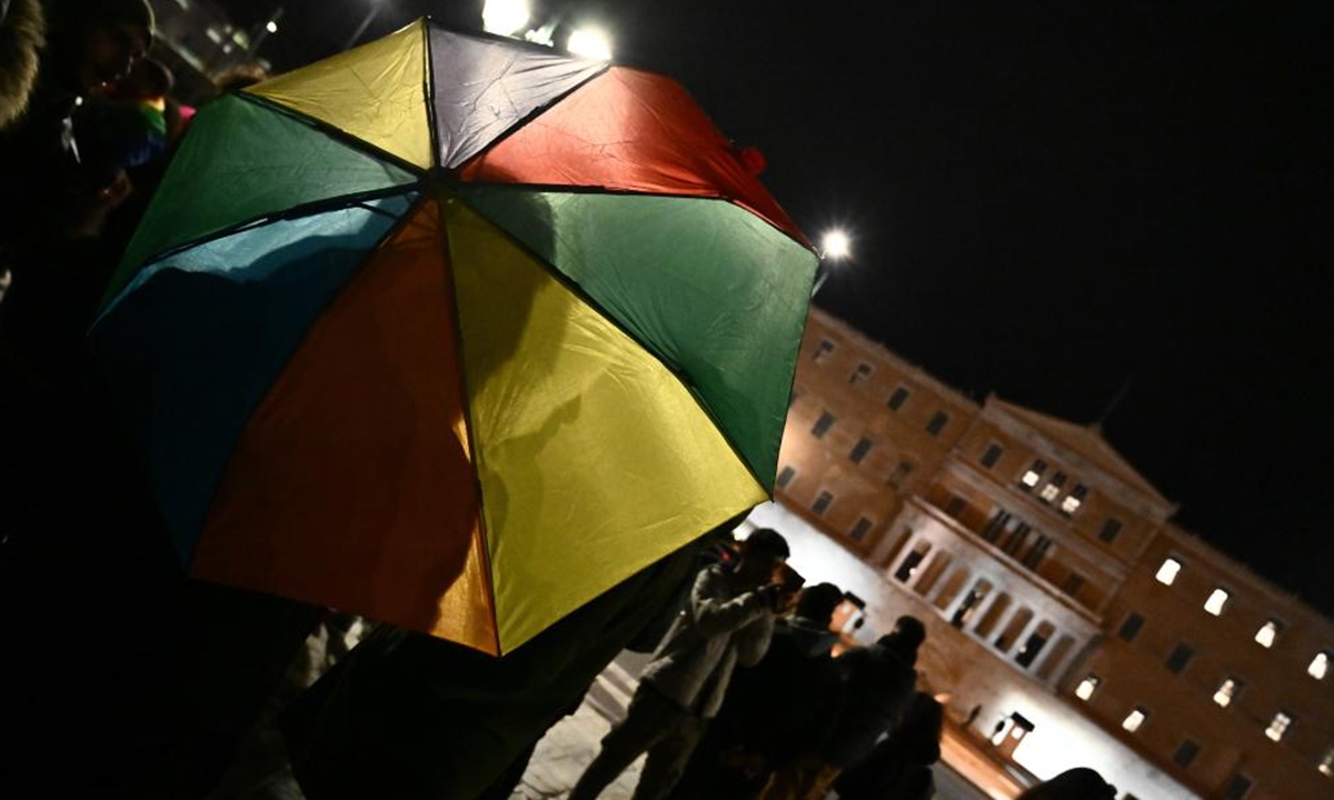 People wait outside the Parliament while the bill on same-sex marriage is debated in Athens, Greece, on Feb. 15, 2024. Greece's parliament approved a landmark bill allowing same-sex civil marriage on Thursday, granting same-sex couples the right to wed and adopt children. (Xinhua/Marios Lolos)