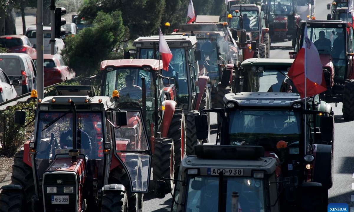 Photo taken on Feb. 15, 2024 shows tractors driving on a road during a farmers' protest in Valletta, Malta. Maltese farmers staged a new wave of protest on Thursday, demanding more economic support from their government and reiterating opposition to some European Union (EU) policies related to agriculture and environment protection. (Photo by Jonathan Borg/Xinhua)