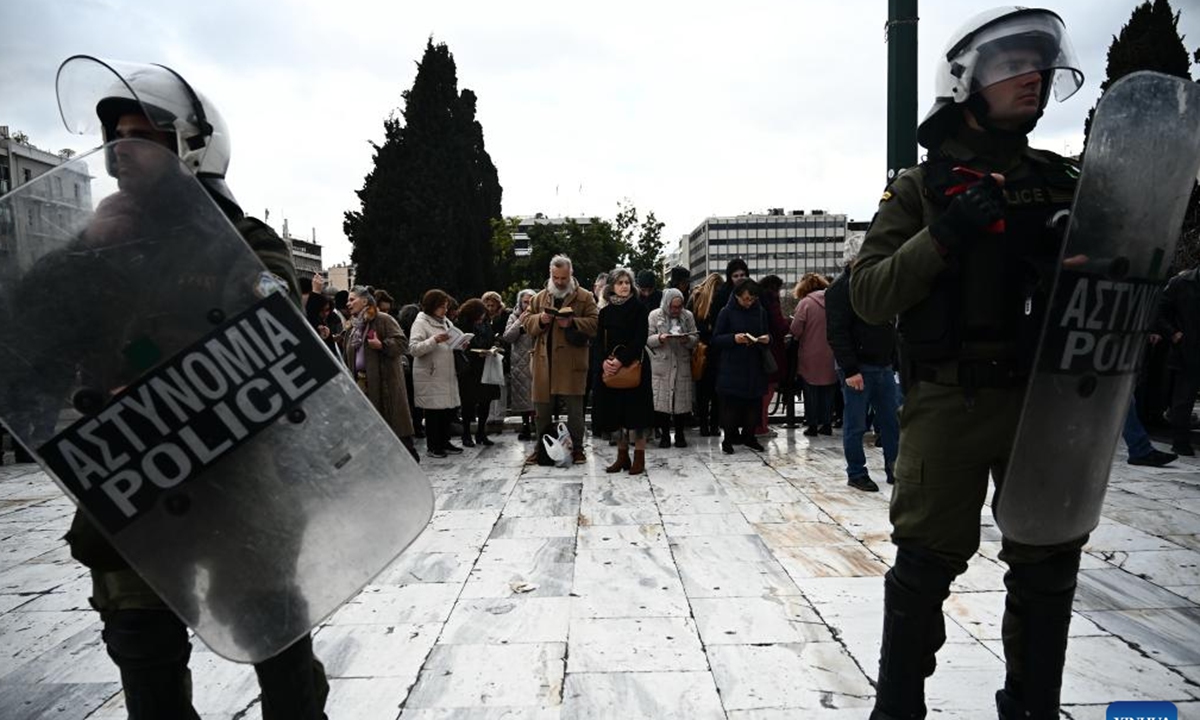 People wait outside the Parliament while the bill on same-sex marriage is debated in Athens, Greece, on Feb. 15, 2024. Greece's parliament approved a landmark bill allowing same-sex civil marriage on Thursday, granting same-sex couples the right to wed and adopt children. (Xinhua/Marios Lolos)