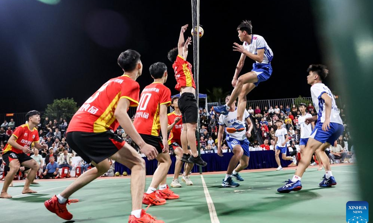 Players participate in a village volleyball match in Wenchang, south China's Hainan Province, Feb. 2, 2024. (Xinhua/Zhang Liyun)