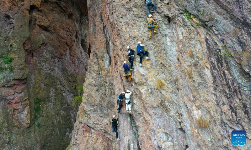 Tourists experience rock climbing at Yandang Mountain in Wenzhou, east China's Zhejiang Province, on Feb. 16, 2024. In addition to following traditional customs, more and more Chinese people choose to enrich their life by spending the Spring Festival holiday in diversified and original ways. (Photo: Xinhua)