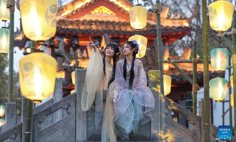 Tourists wearing traditional costumes visit a scenic area in Xiangyang, central China's Hubei Province, Feb. 13, 2024. In addition to following traditional customs, more and more Chinese people choose to enrich their life by spending the Spring Festival holiday in diversified and original ways. (Photo: Xinhua)