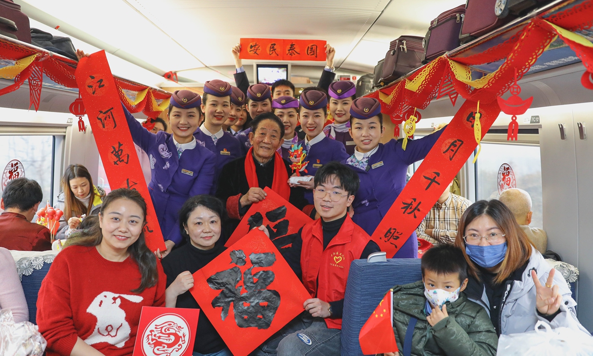 Volunteers celebrate the Lunar New Year with passengers on a high-speed train from Qingdao, East China's Shandong, to Beijing, on January 31, 2024. Photo: IC