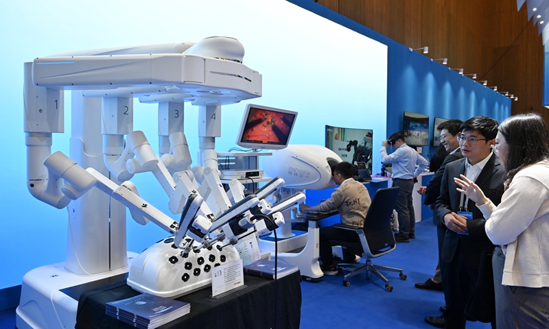 Visitors observe a surgical robot at an exhibition on February 18, 2024 in Shenzhen, South China’s Guangdong Province. The exhibition is being held on the sidelines of the Guangdong Provincial High-Quality Development Conference, which showcases achievements of industrial integration in emerging fields such as medical equipment, artificial intelligence and chips. Photo: VCG