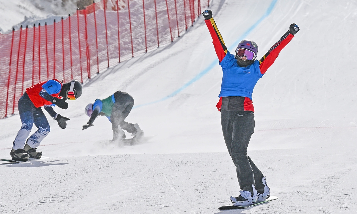 Snowboarder Yongqing Lamu, representing Southwest China's Xizang Autonomous Region, celebrates after winning gold in the youth group of the snowboard cross final at the 14th National Winter Games in Ulanqab, North China's Inner Mongolia Autonomous Region. This is the first time Xizang has sent a delegation to the National Winter Games. Photo: Courtesy of the organizing committee