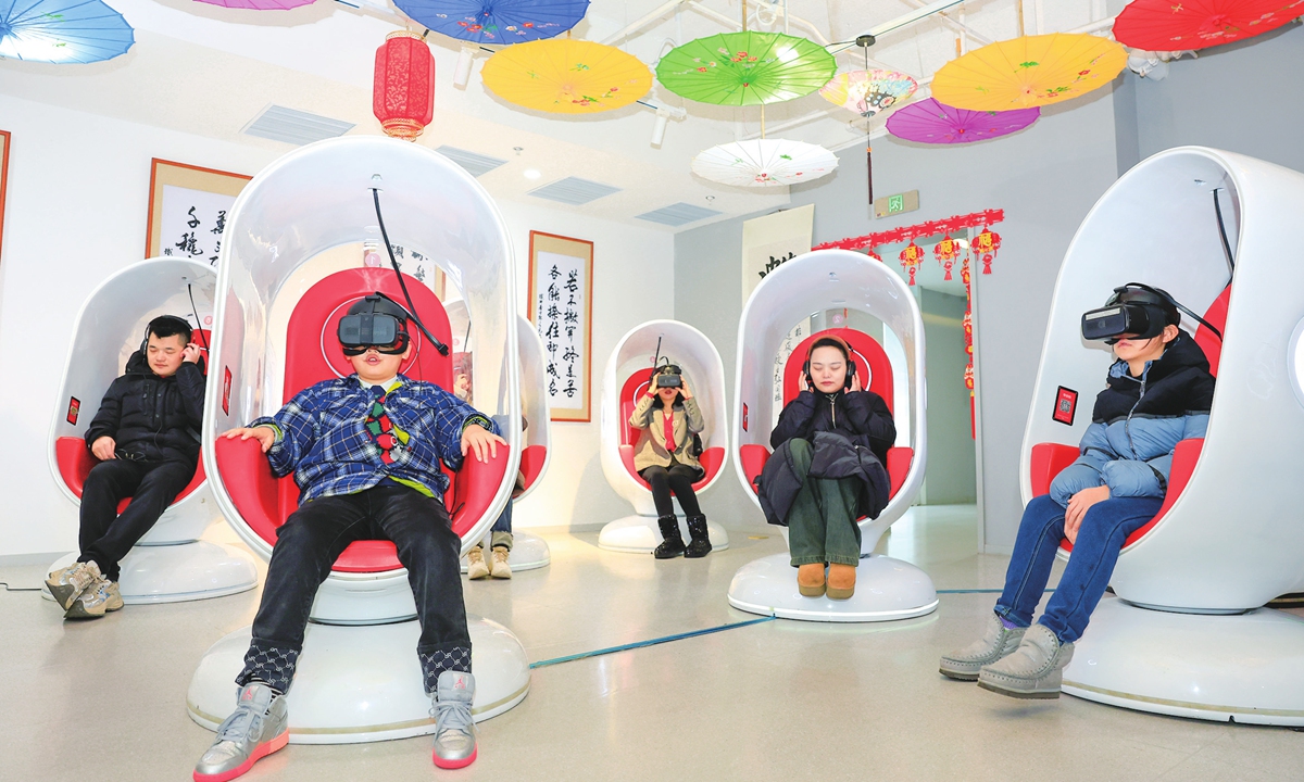 People experience virtual reality (VR) equipment in a cultural center in Hefei, East China's Anhui Province on February 20, 2024. The center closely links traditional Chinese culture with VR technology, with functions such as the metaverse experience and VR consumption that meet the local public's demand for experience in emerging consumption modes. Photo: VCG