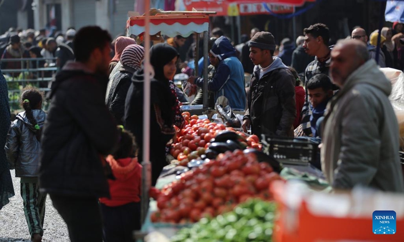 People shop at a market in central Gaza Strip city of Deir el-Balah, Feb. 19, 2024.(Photo: Xinhua)