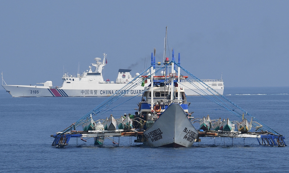 Chinese Coast Guard vessels (rear) patrol the waters near Huangyan Dao in the South China Sea, on September 20, 2023. Photo: Visual News