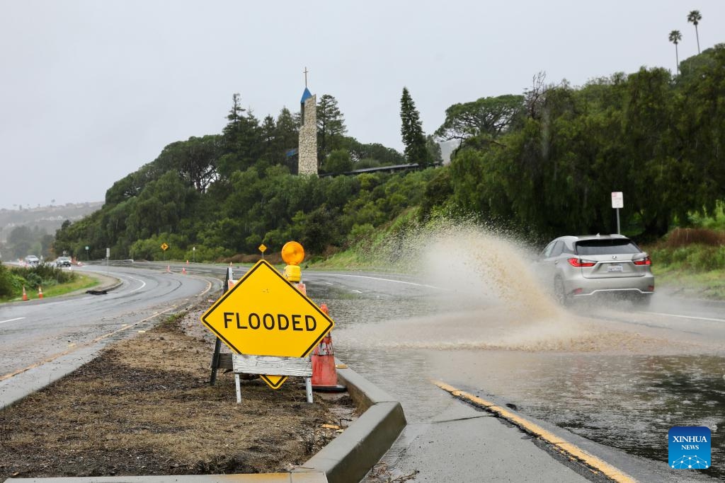 A road is flooded near the Wayfarers Chapel in Rancho Palos Verdes, Los Angeles County, California, the United States, Feb. 20, 2024. A powerful storm continues to slam the U.S. West Coast on Tuesday with heavy rain, snow and wind, as flood watch remains in effect across California.(Photo: Xinhua)
