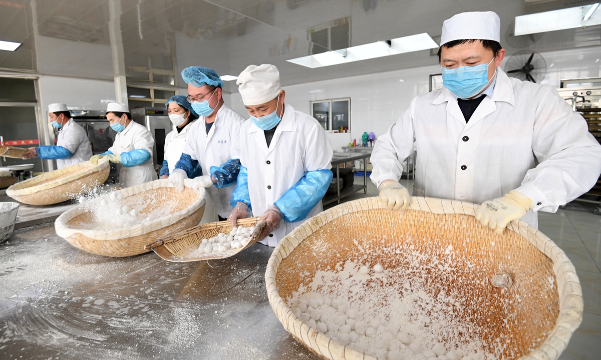 Dessert chefs make yuanxiao, or glutinous rice balls, in the traditional way ahead of the Lantern Festival in Zhangjiakou, North China's Hebei Province on February 22, 2024. The Lantern Festival this year falls on February 24, and searches for