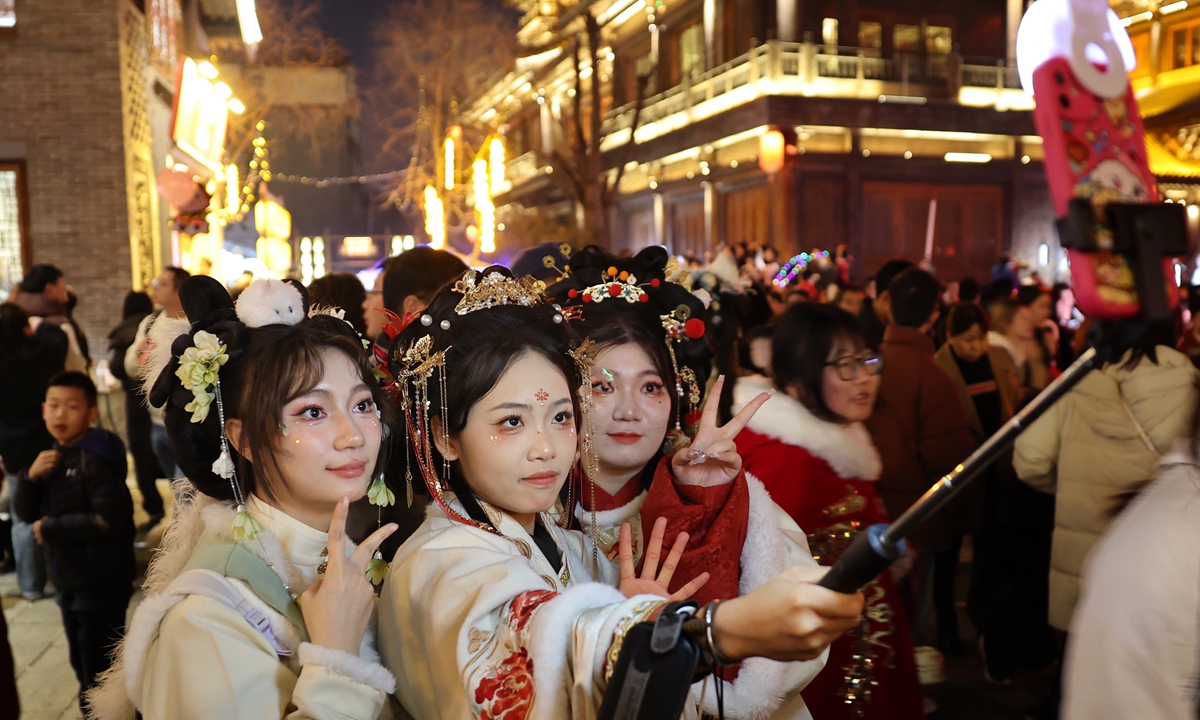 Tourists dressed in Hanfu take photos and experience traditional Chinese culture in Luoyi ancient city in Luoyang, Central China's Henan Province, on February 13, 2024, the fourth day of the Chinese New Year. Photo: VCG