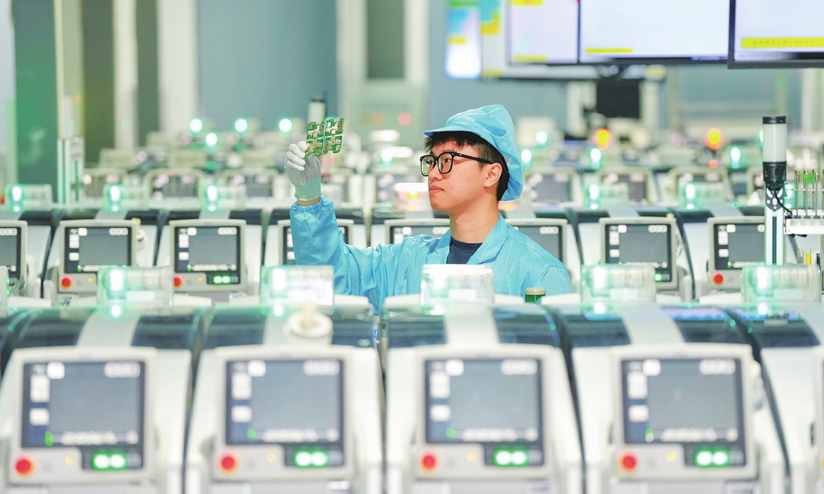 An employee inspects a cellphone chip at an electronic product research and development company in Ningbo, East China’s Zhejiang Province on February 22, 2024. The company’s products are exported to more than 80 countries in Europe and Latin America, and its overseas order book is full through the second quarter of 2024. Photo: VCG
