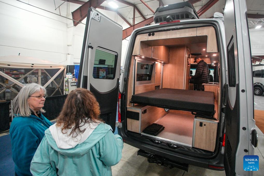 People visit a recreational vehicle at the Earlybird RV Show and Sale in Abbotsford, British Columbia, Canada, on Feb. 22, 2024. Featuring over 200 recreational vehicles from 45 exhibitors in North America, the Earlybird RV Show and Sale runs from Feb. 22 to Feb. 25.(Photo: Xinhua)