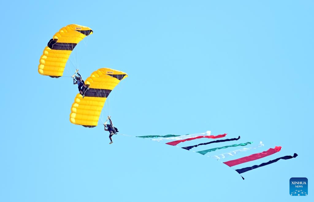 Skydivers make stunt moves during a show in Ahmadi Governorate, Kuwait, Feb. 22, 2024. A skydiving show is held on Thursday to celebrate the upcoming National Day of Kuwait.(Photo: Xinhua)