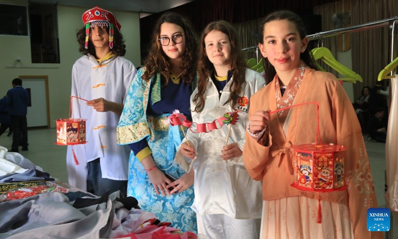 Students wearing traditional Chinese clothing pose for a group photo at a school in Pembroke, Malta, on Feb. 22, 2024. On Thursday, an event for the Chinese Lantern Festival was held at St. Clare Pembroke Secondary School, northeastern Malta, featuring singing and dancing, Chinese paper-cuts, tasting of dumplings, and trying on traditional Chinese clothing known as Hanfu.(Photo: Xinhua)