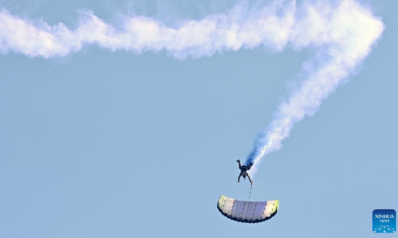 A skydiver makes stunt moves during a show in Ahmadi Governorate, Kuwait, Feb. 22, 2024. A skydiving show is held on Thursday to celebrate the upcoming National Day of Kuwait(Photo: Xinhua)