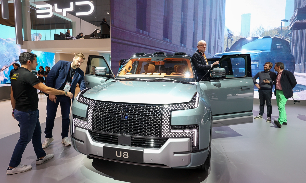 Visitors take a look at the Yangwang U8, a luxury plug-in hybrid sport utility vehicle made by China's BYD, at the Geneva International Motor Show on February 26, 2024. Chinese new-energy car firms are accelerating their overseas expansion. Data from the China Passenger Car Association shows that vehicle exports reached 5.22 million in 2023, a year-on-year increase of 54 percent. Photo: VCG