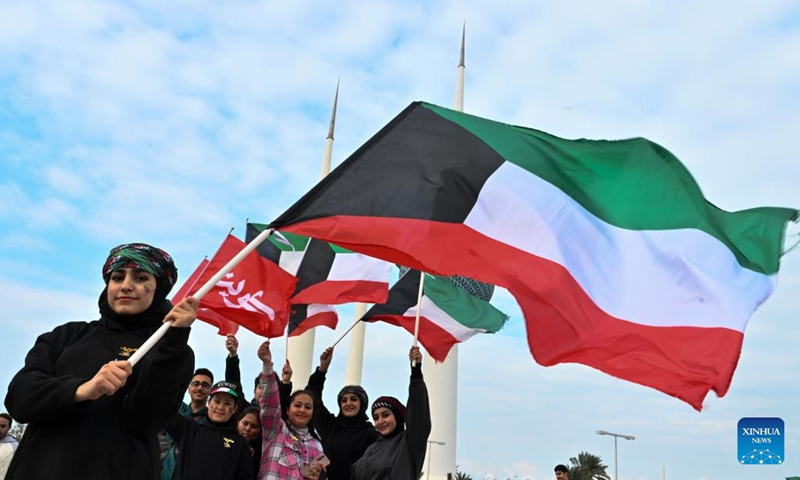 People carry Kuwait's national flags during the celebration in Capital Governorate, Kuwait, Feb. 25, 2024. Kuwaitis celebrate their national and liberation days on Feb. 25 and 26 every year.(Photo: Xinhua)